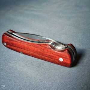 Spring folder knife with padouk handle scales closed blade side view