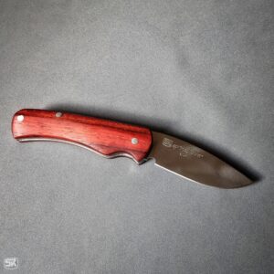 Spring folder knife with padouk handle scales, top view