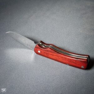 Spring folder knife with padouk handle scales side view