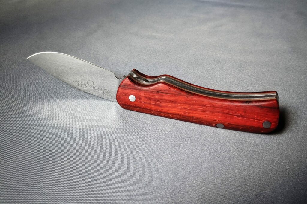 Spring folder knife header image with padouk handle scales